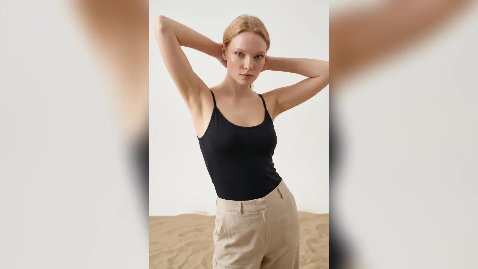 Virtual model in a black top and beige trousers on a sand set: Instagram storefront frame example