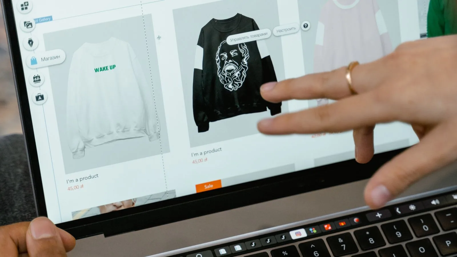 Hands browsing an online clothing store product page on a laptop